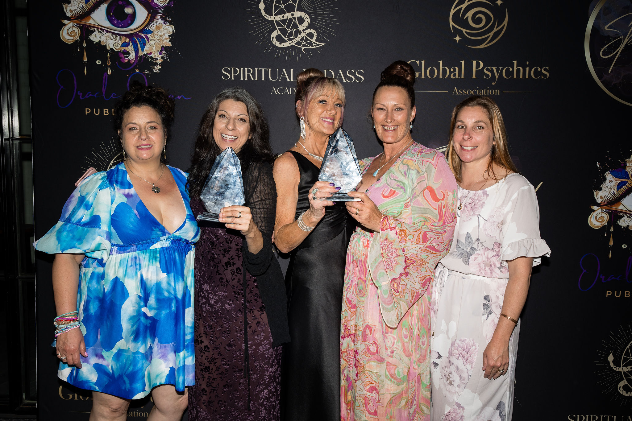 Winners posing with trophies at the SLAI media wall